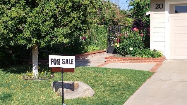 Residential property with "For Sale" sign in the front