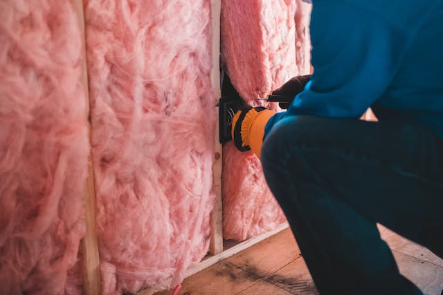 contractor-installing-pink-wall-insulation