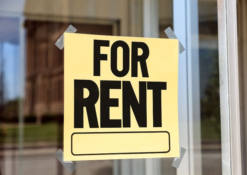 yellow for rent sign taped in a window