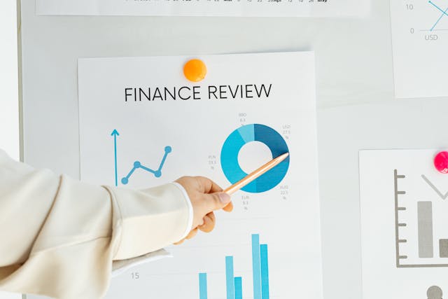 person pointing to a graph on a financial review form